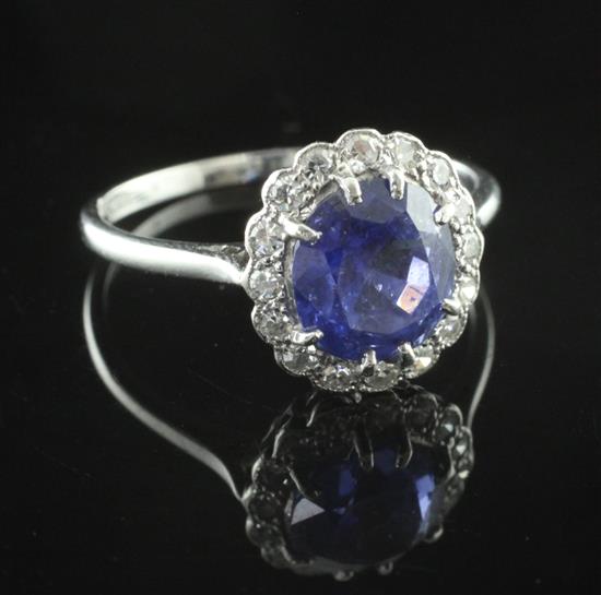 An 18ct white gold and platinum, sapphire and diamond oval cluster ring, size N.